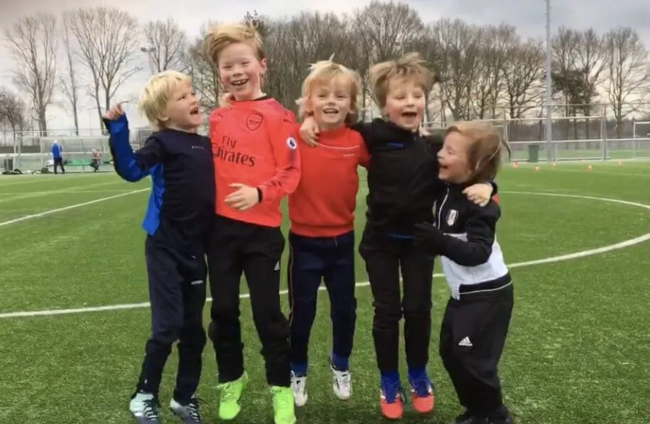 Positive coaching in youth football — happy children on the pitch